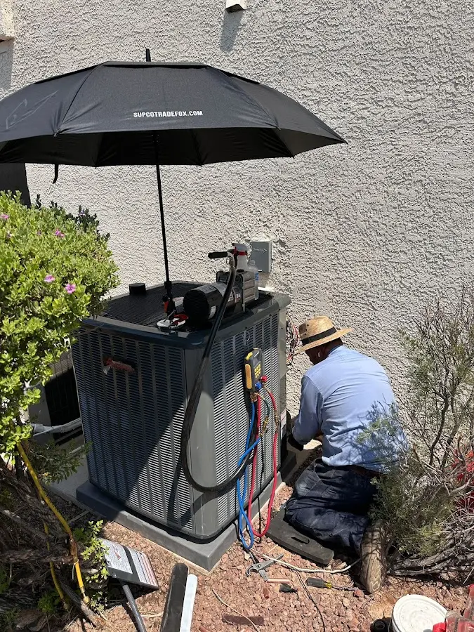 HVAC technician performing outdoor AC maintenance in Cedar Falls
